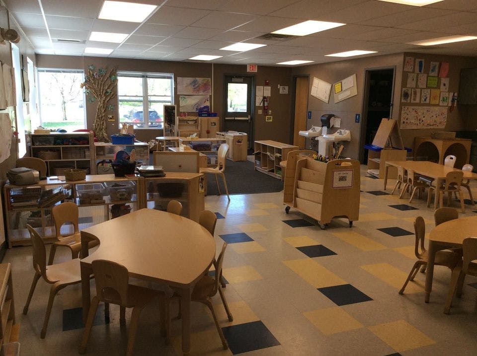 Empty classroom with small tables and chairs