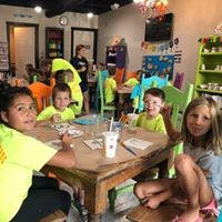 Children sitting at tables in a room