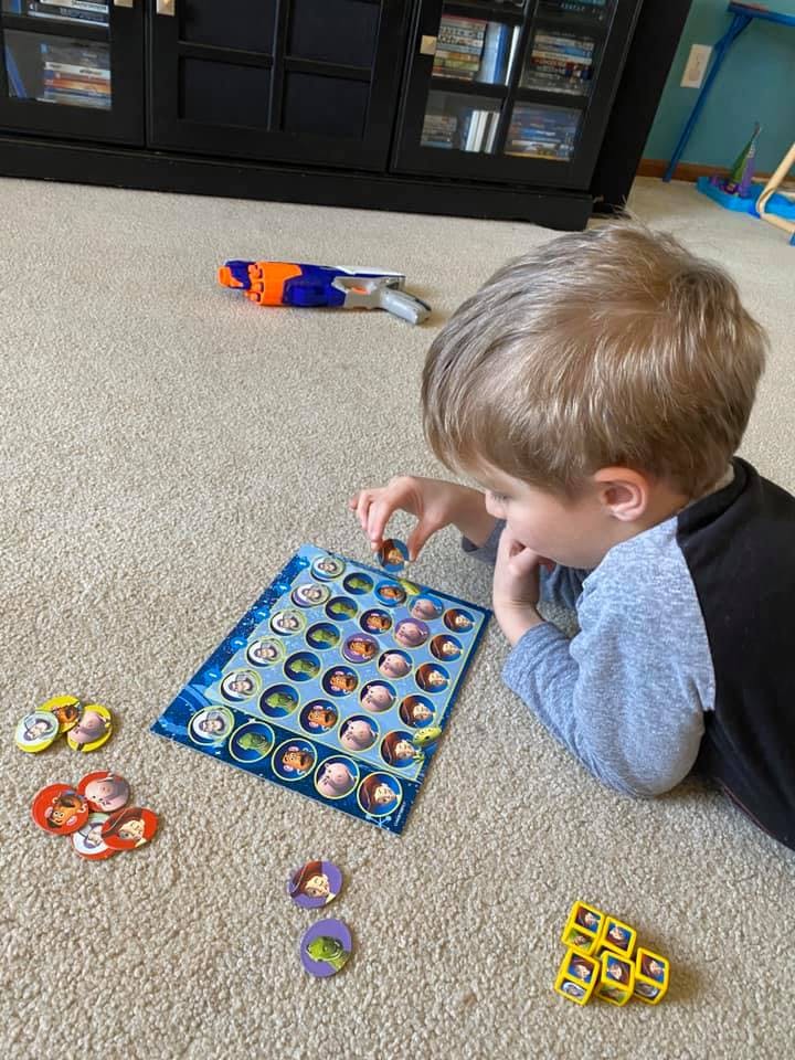 Child playing a board game on the floor