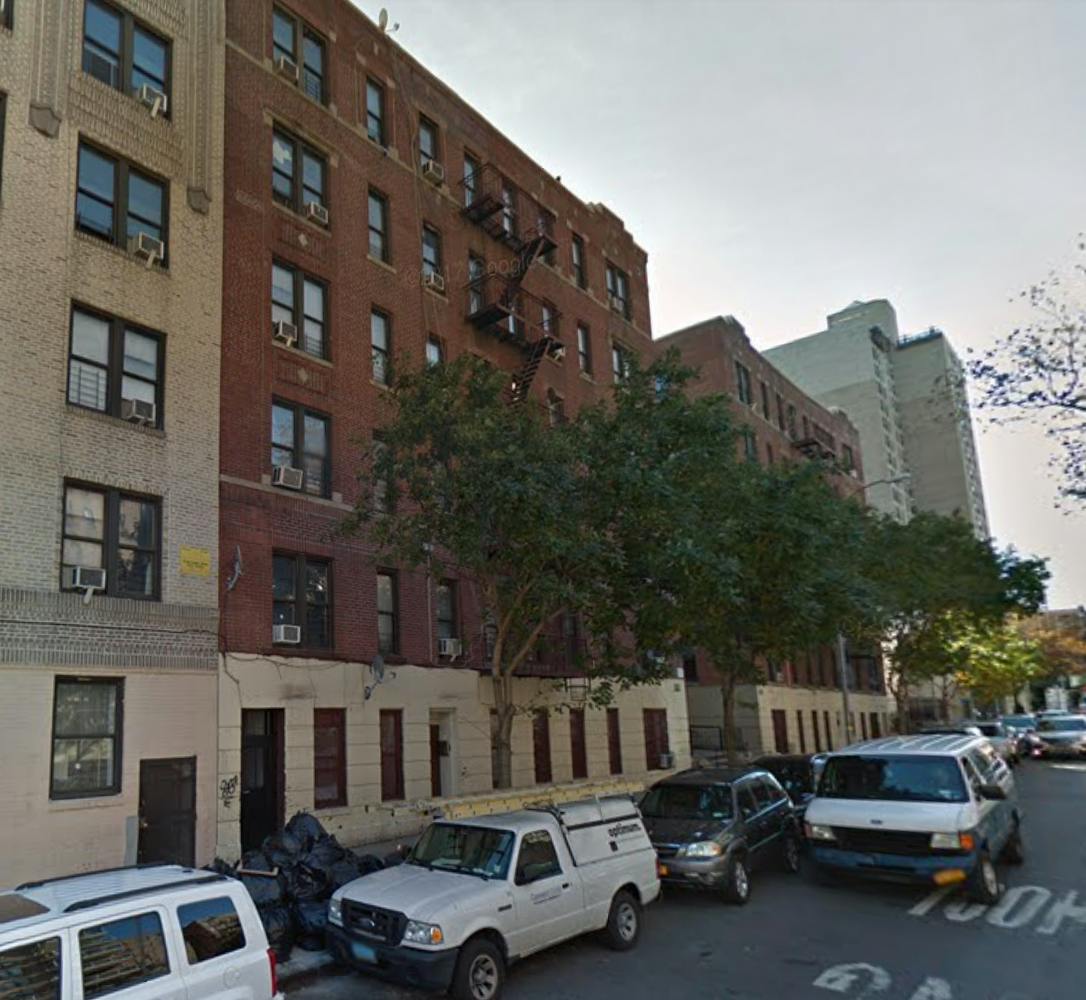 Street view of apartment buildings and parked cars
