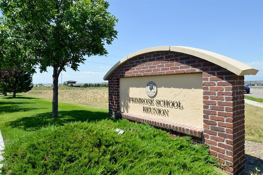 Brick sign with "Primrose School Reunion" text