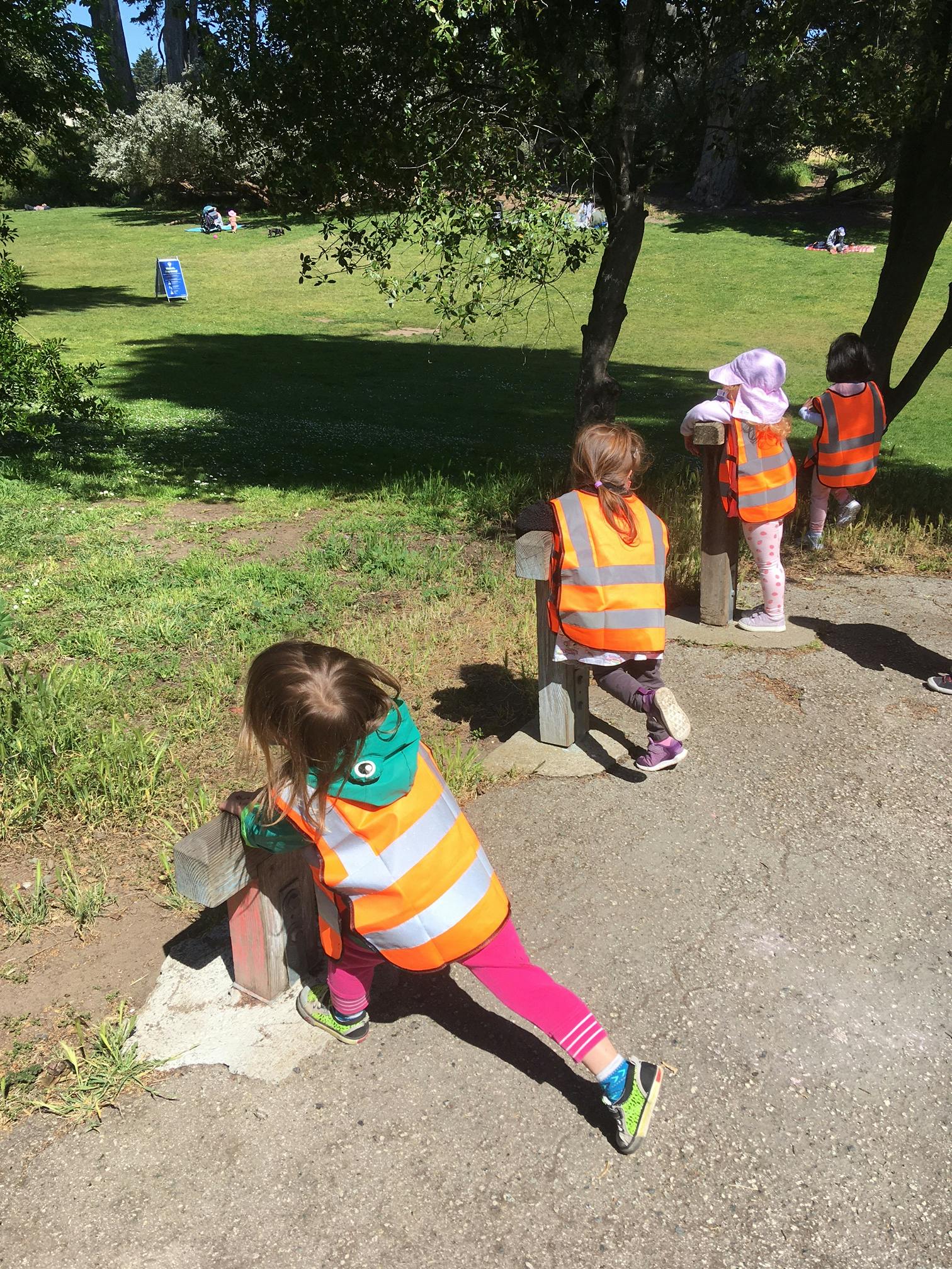 Children in safety vests playing outdoors