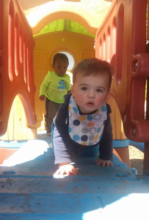 Two children on a colorful playground structure