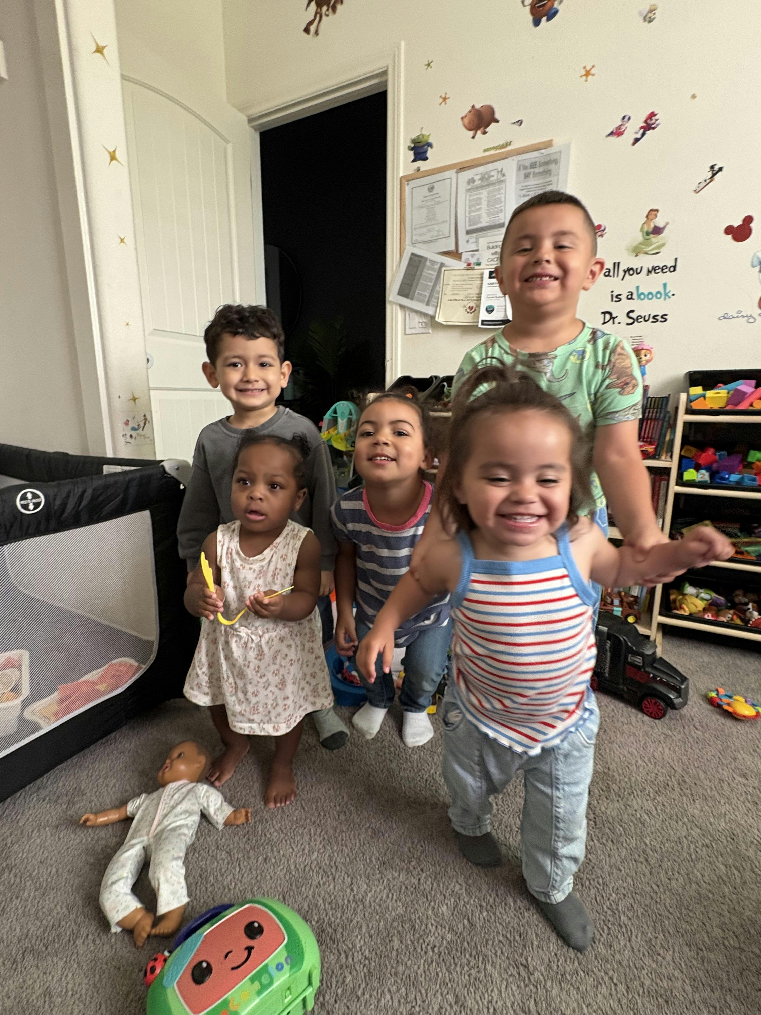 Group of children standing together in a playroom