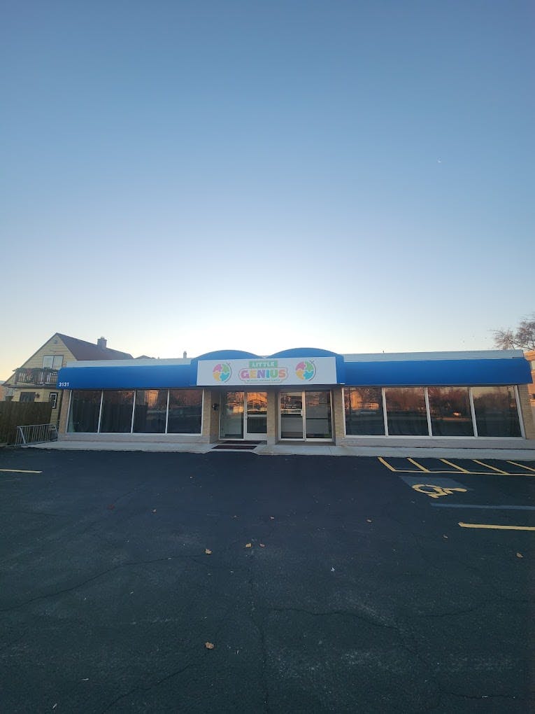 Building with blue awning and sign that reads "Happy Kids"