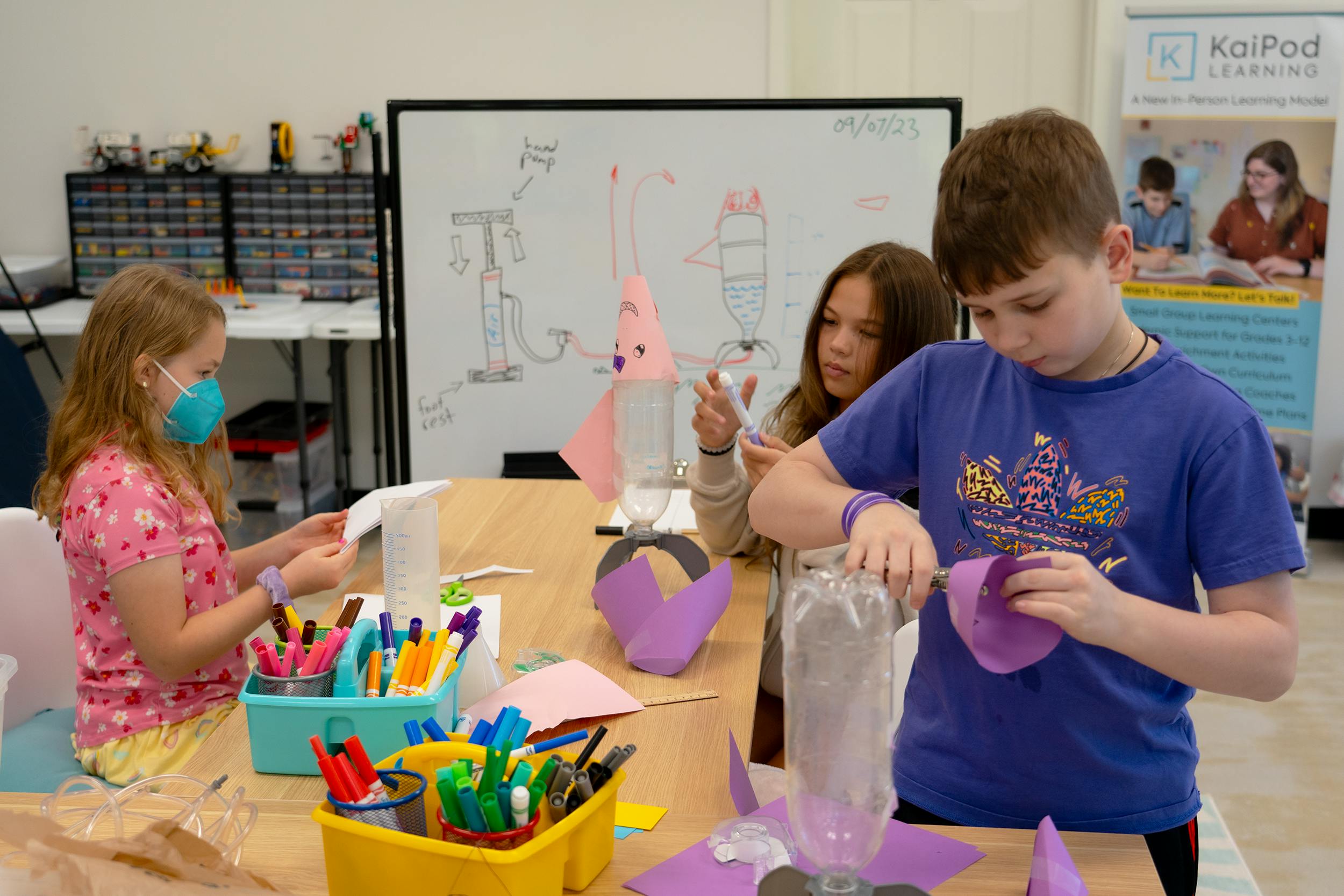 Children making crafts at a table