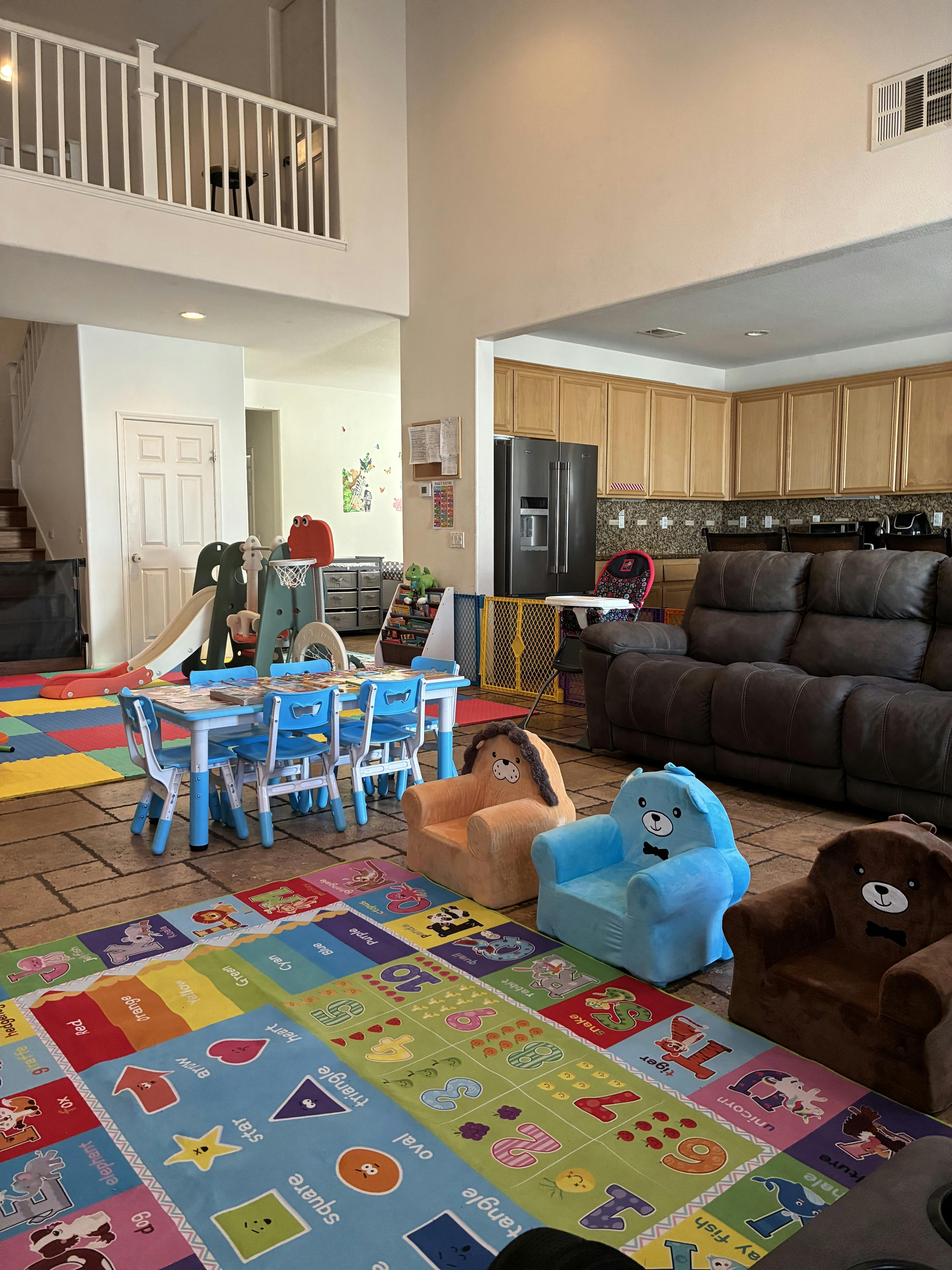 Living room with children's play area, small table and chairs, and plush animal chairs