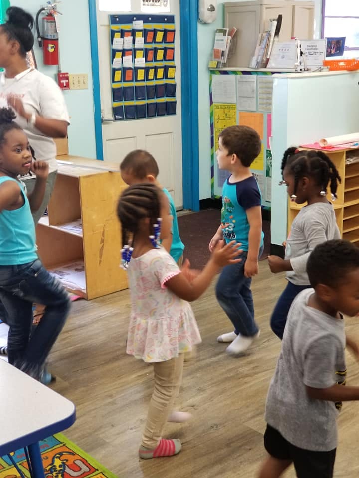Children dancing in a classroom