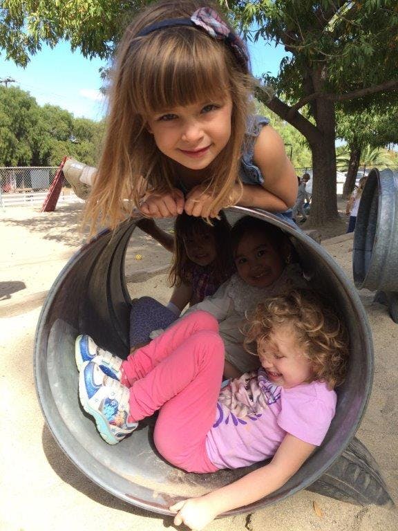 Children playing in a tunnel on a playground