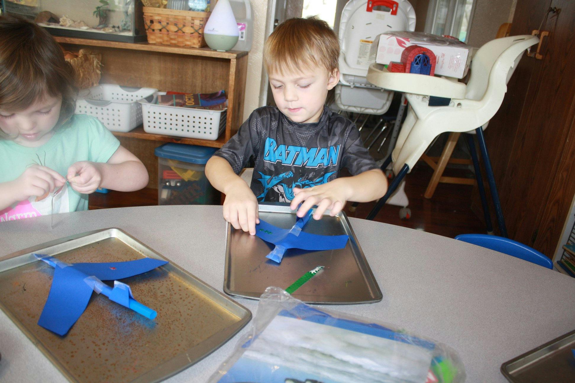 Two children making crafts at a table