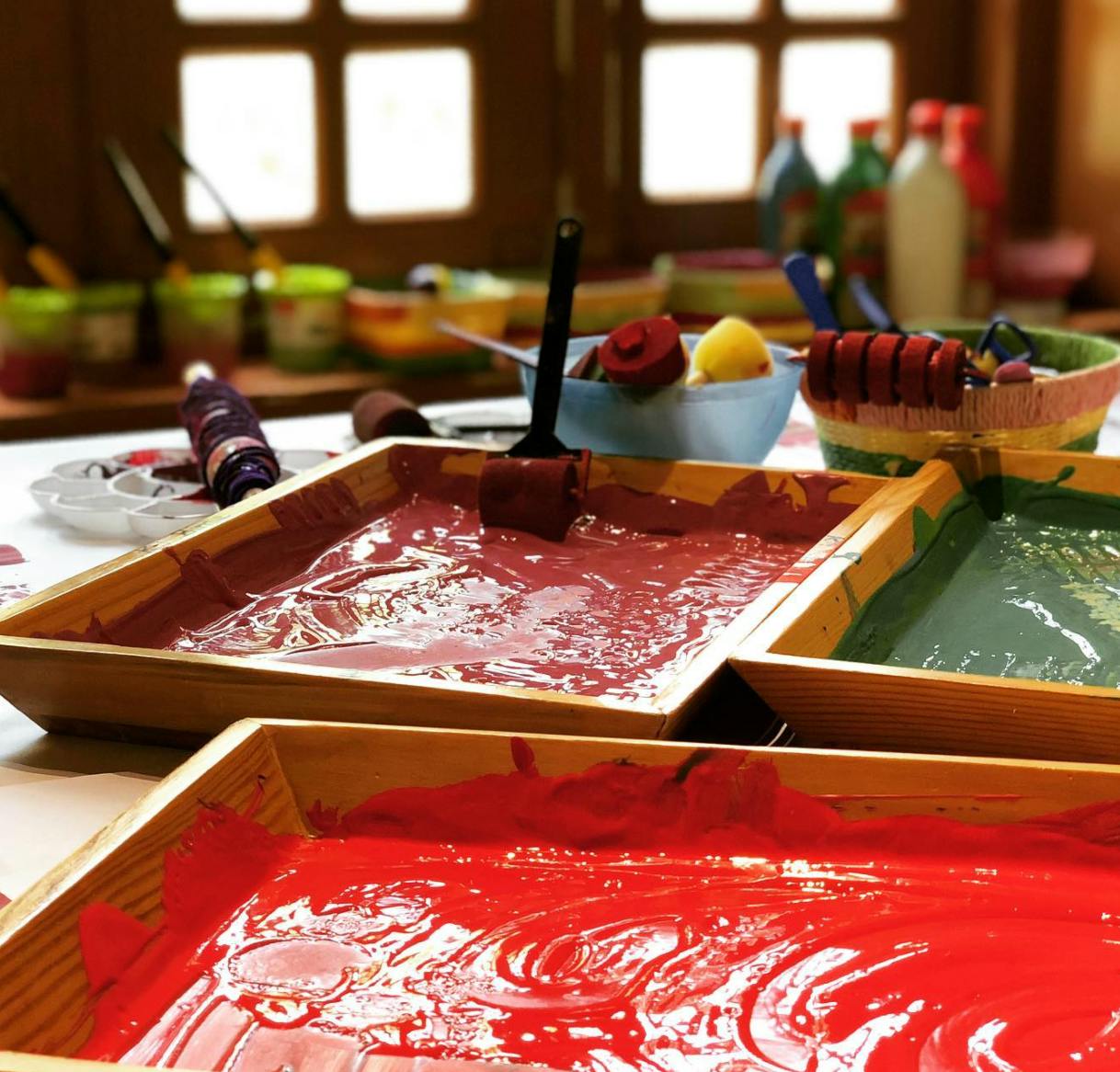 Trays of red and green paint with brushes