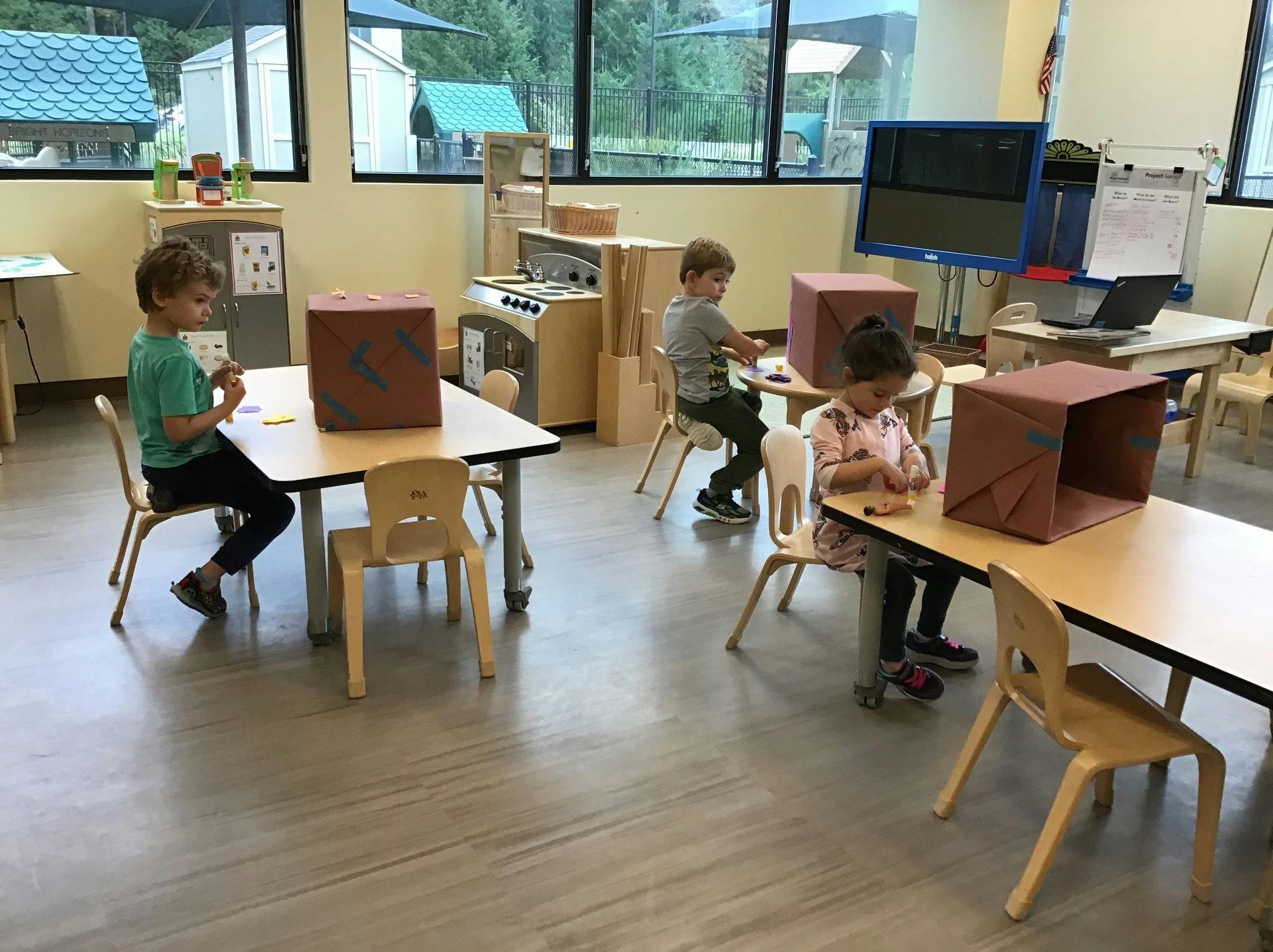 Children sitting at tables in a classroom