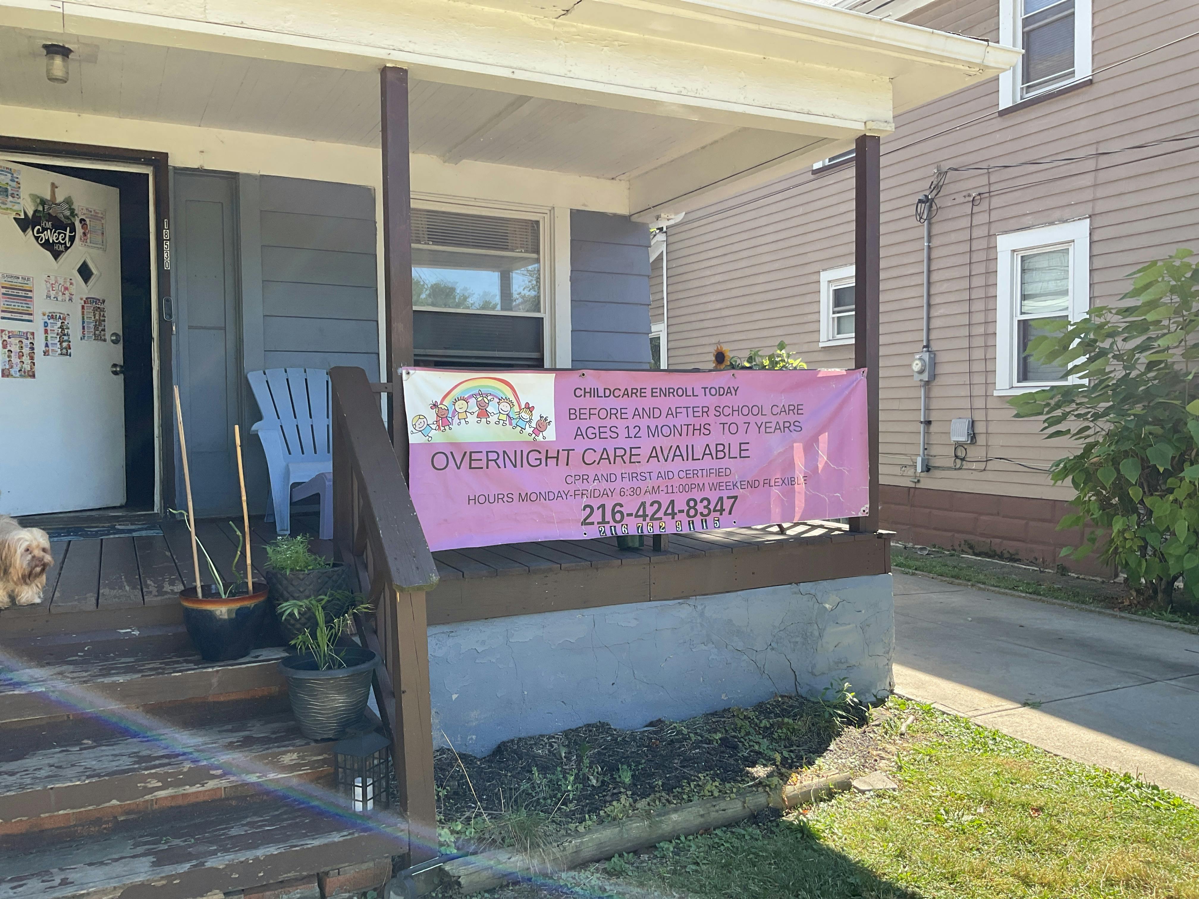Childcare advertisement banner on a house porch