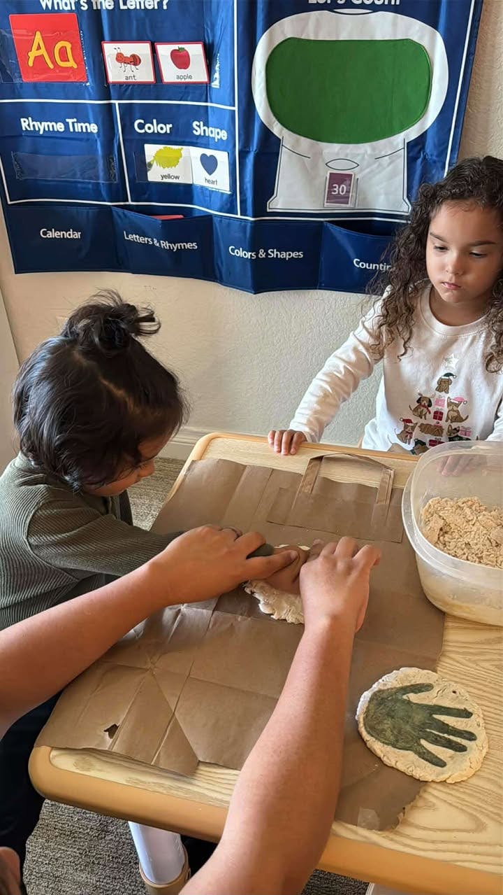 Two children making crafts at a table