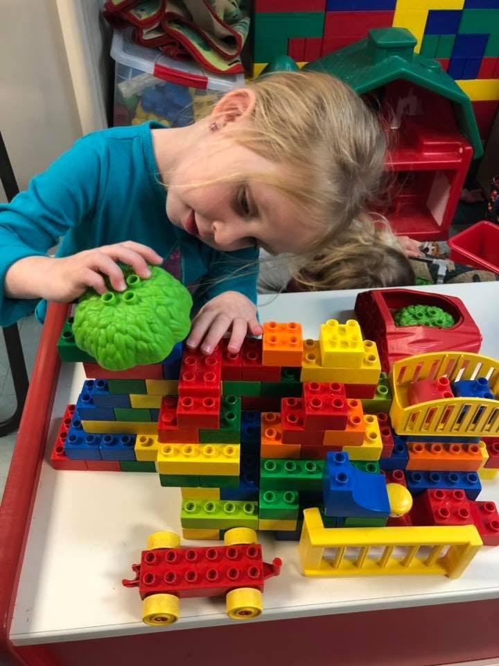 Child playing with colorful building blocks