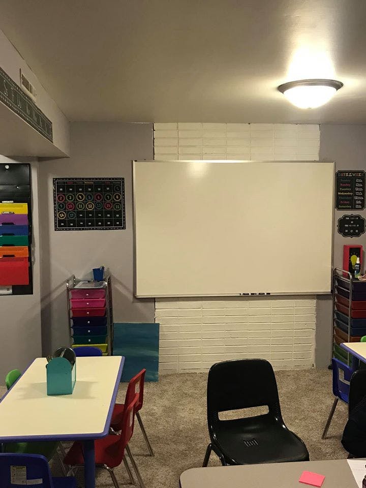 Classroom with a whiteboard, tables, and chairs