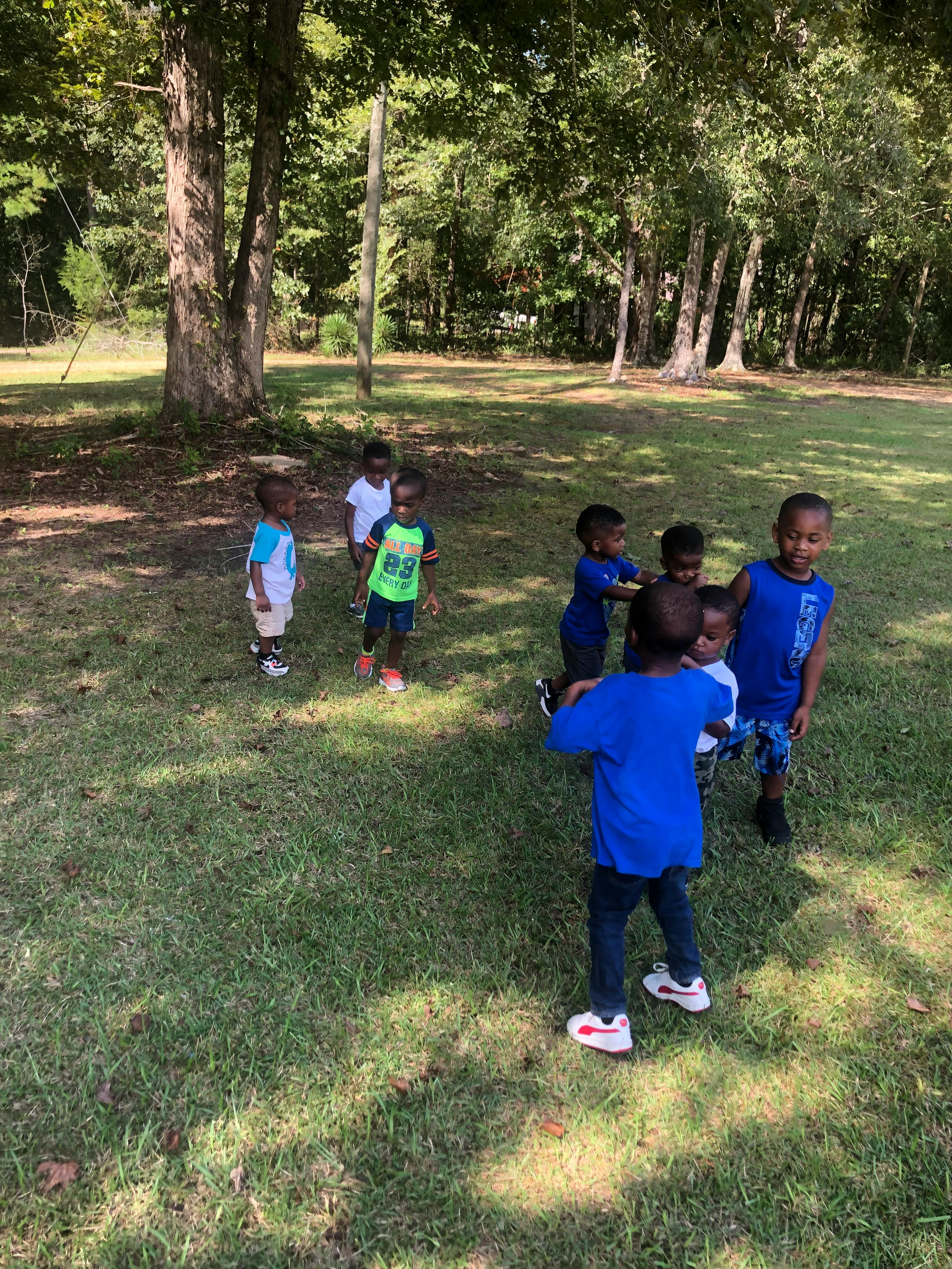 Group of children playing outdoors on grass
