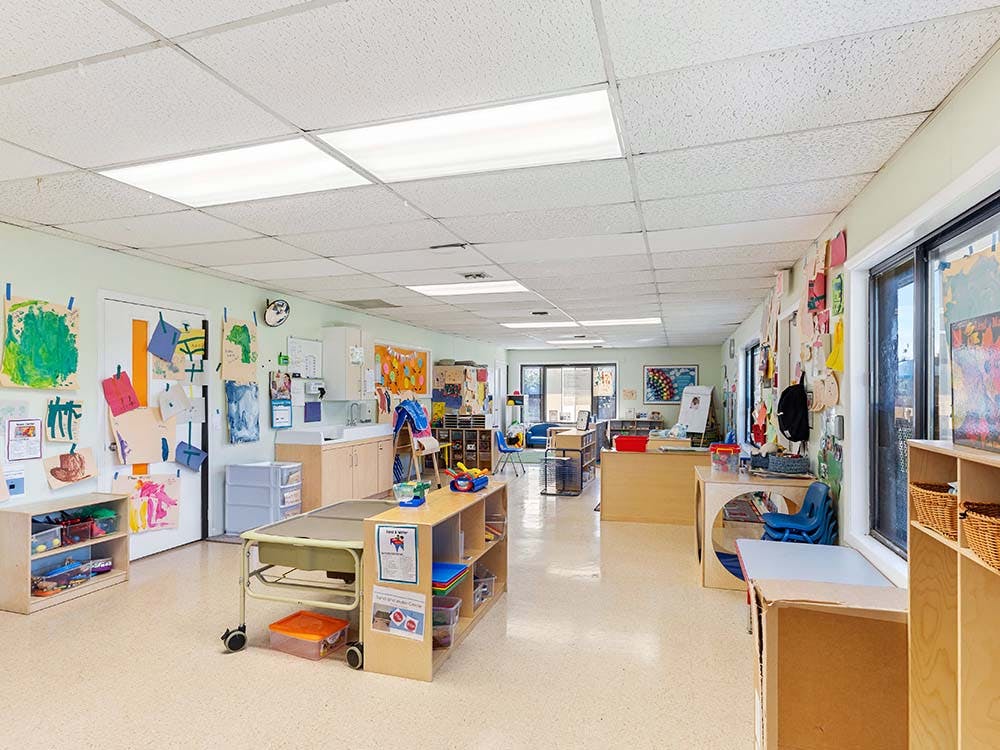 Empty classroom with student artwork on the walls and various learning stations