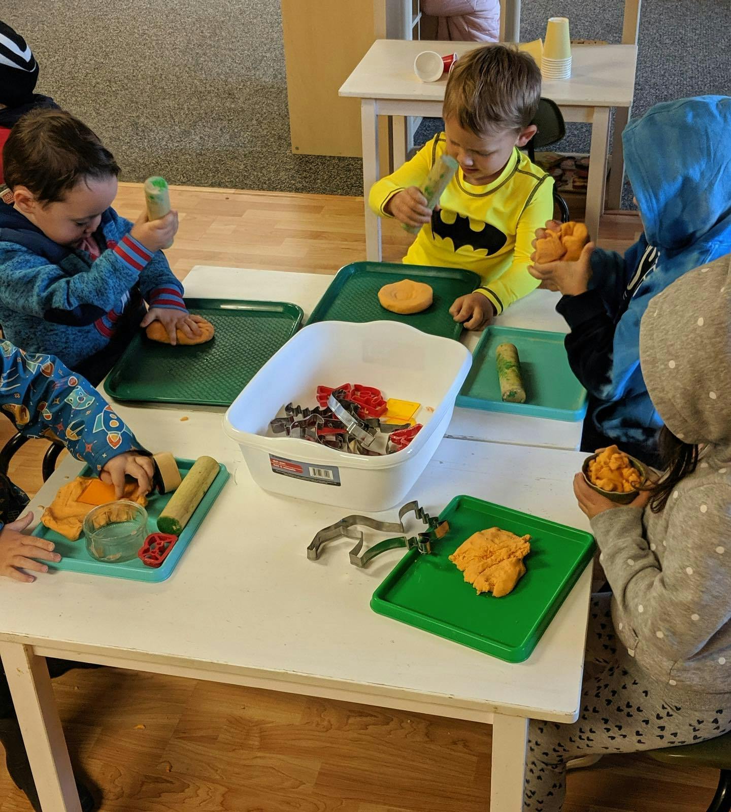 Children playing with modeling clay at a table