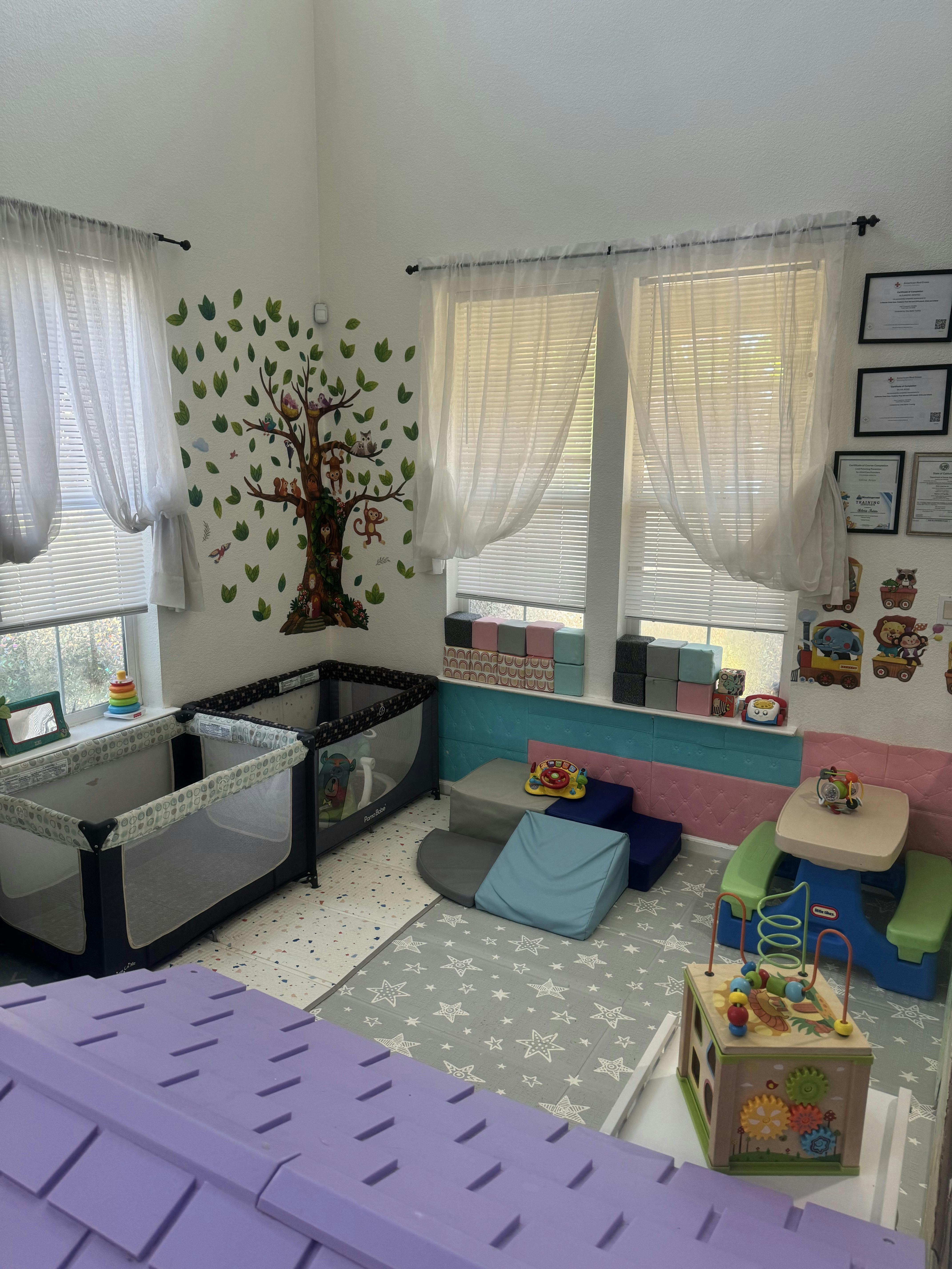 Playroom with a crib, foam climbing blocks, and activity toys