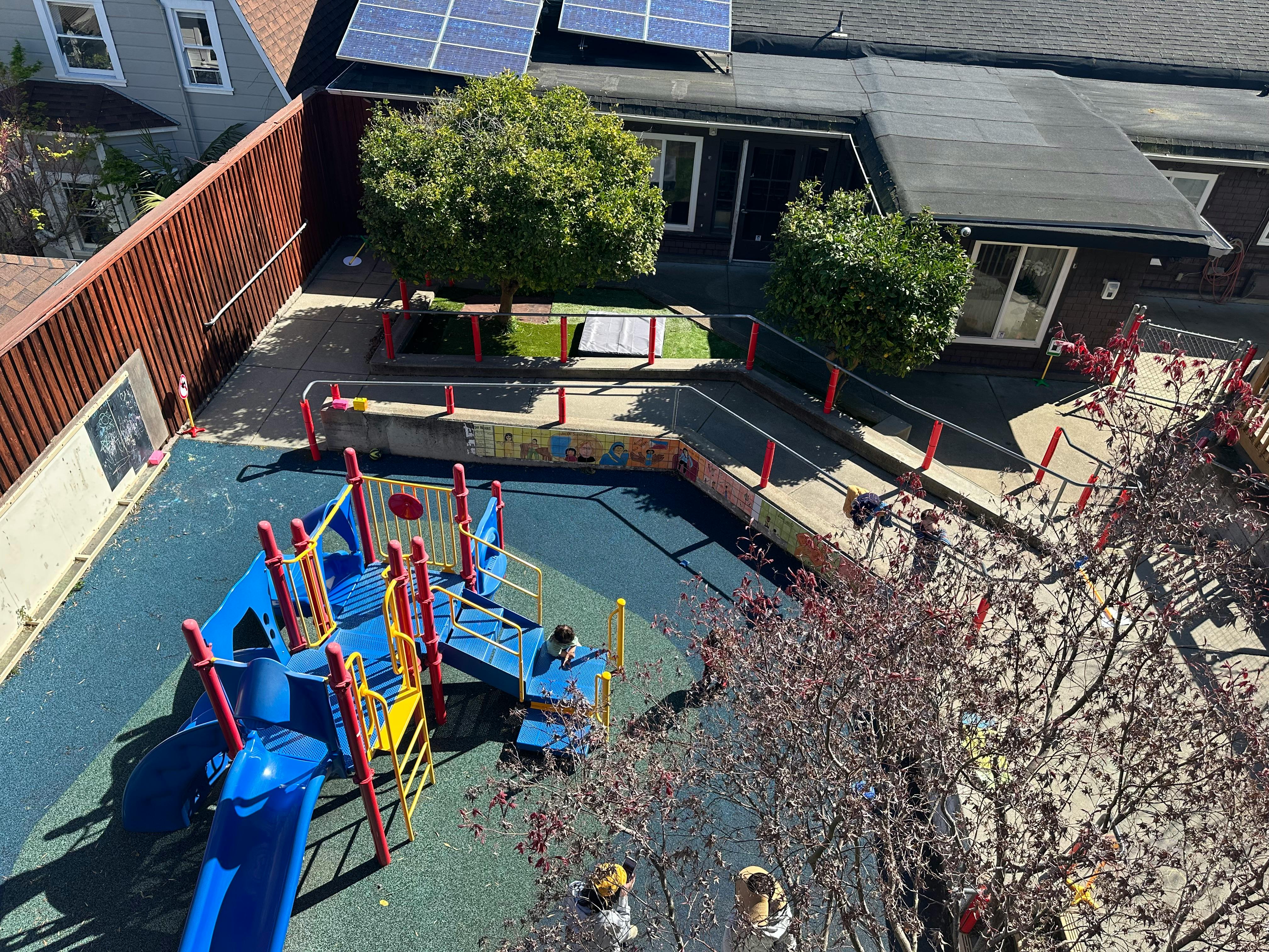 Playground with blue and yellow play structure and slides
