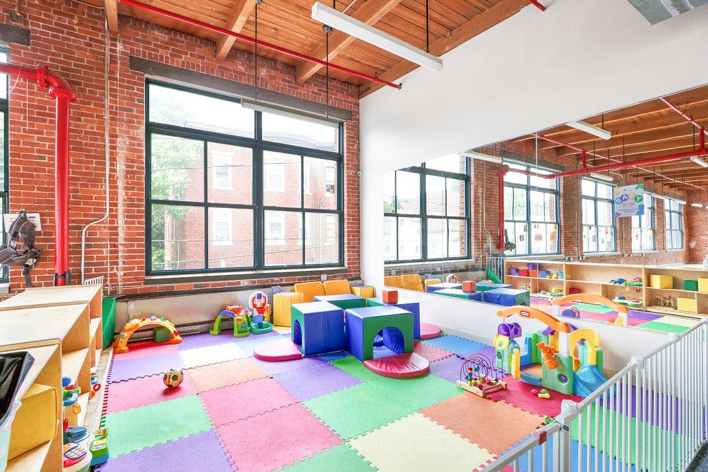 Indoor play area with colorful floor mats and soft play equipment