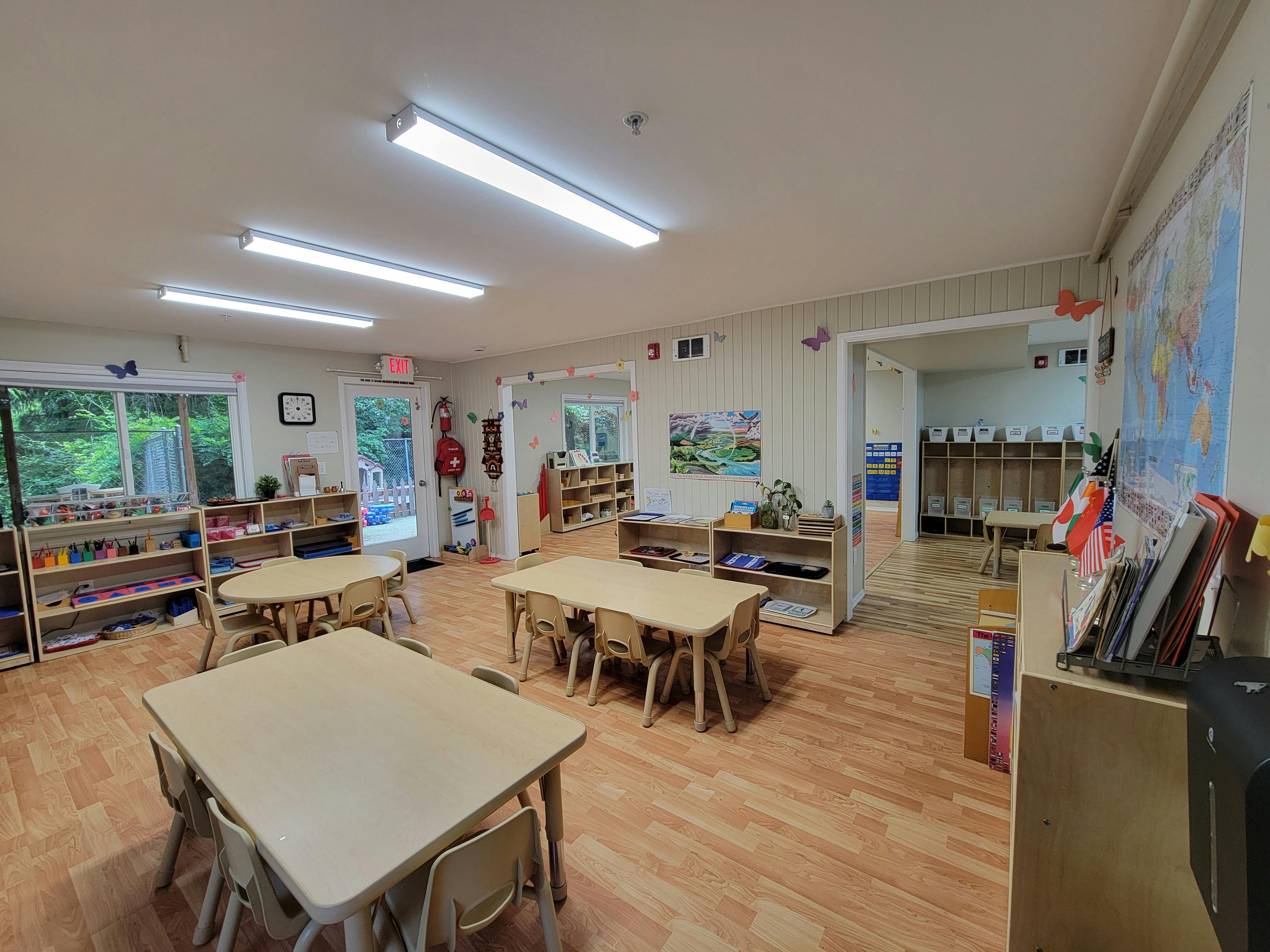 Empty classroom with small tables and chairs
