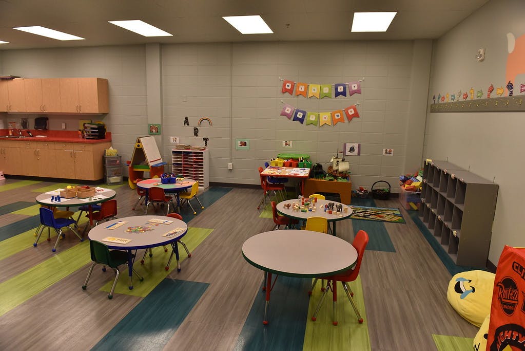 Empty classroom with small tables and chairs