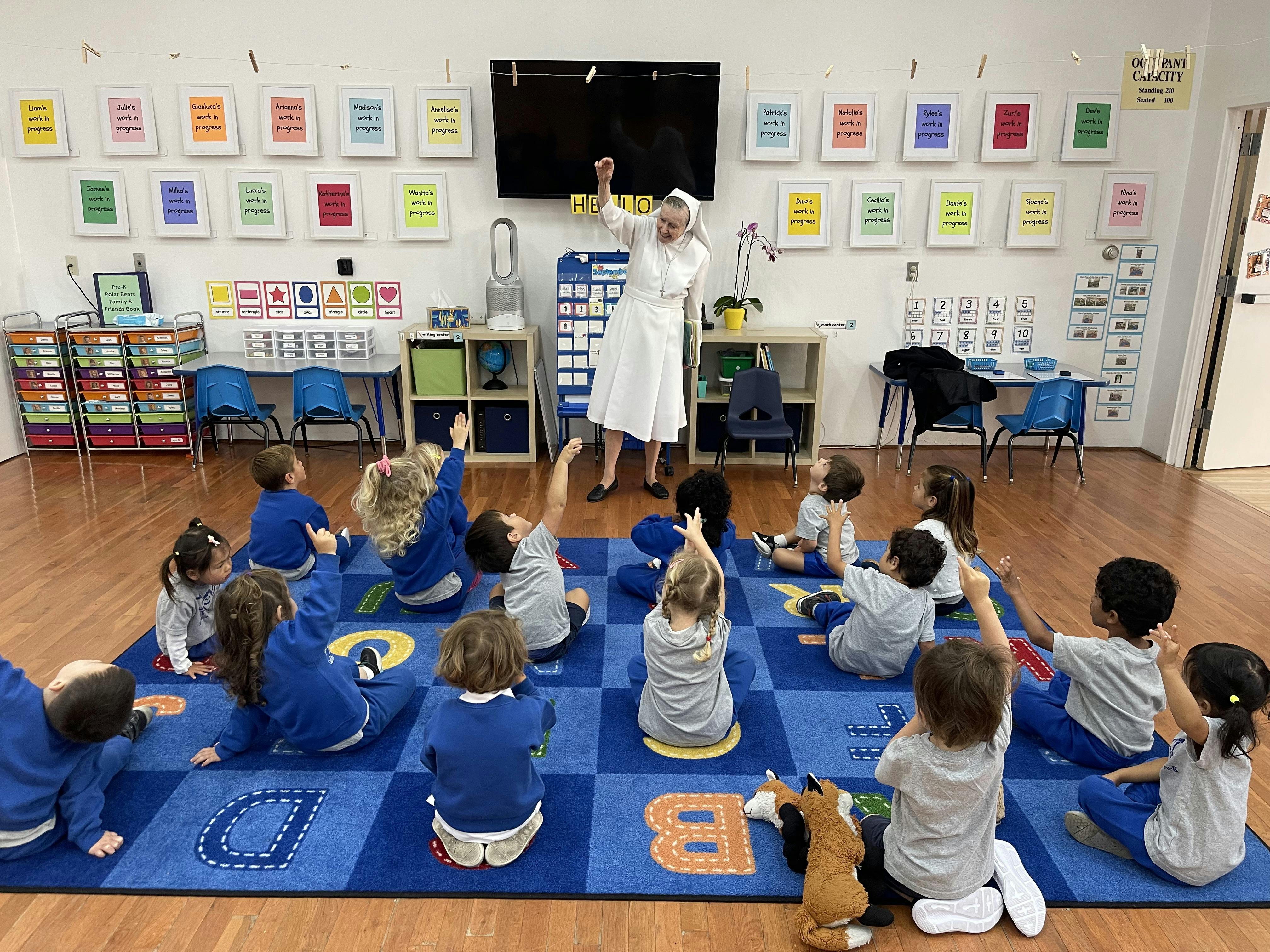 Person leading children in a classroom