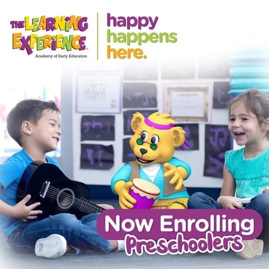 Child with guitar, mascot with drum, and child laughing