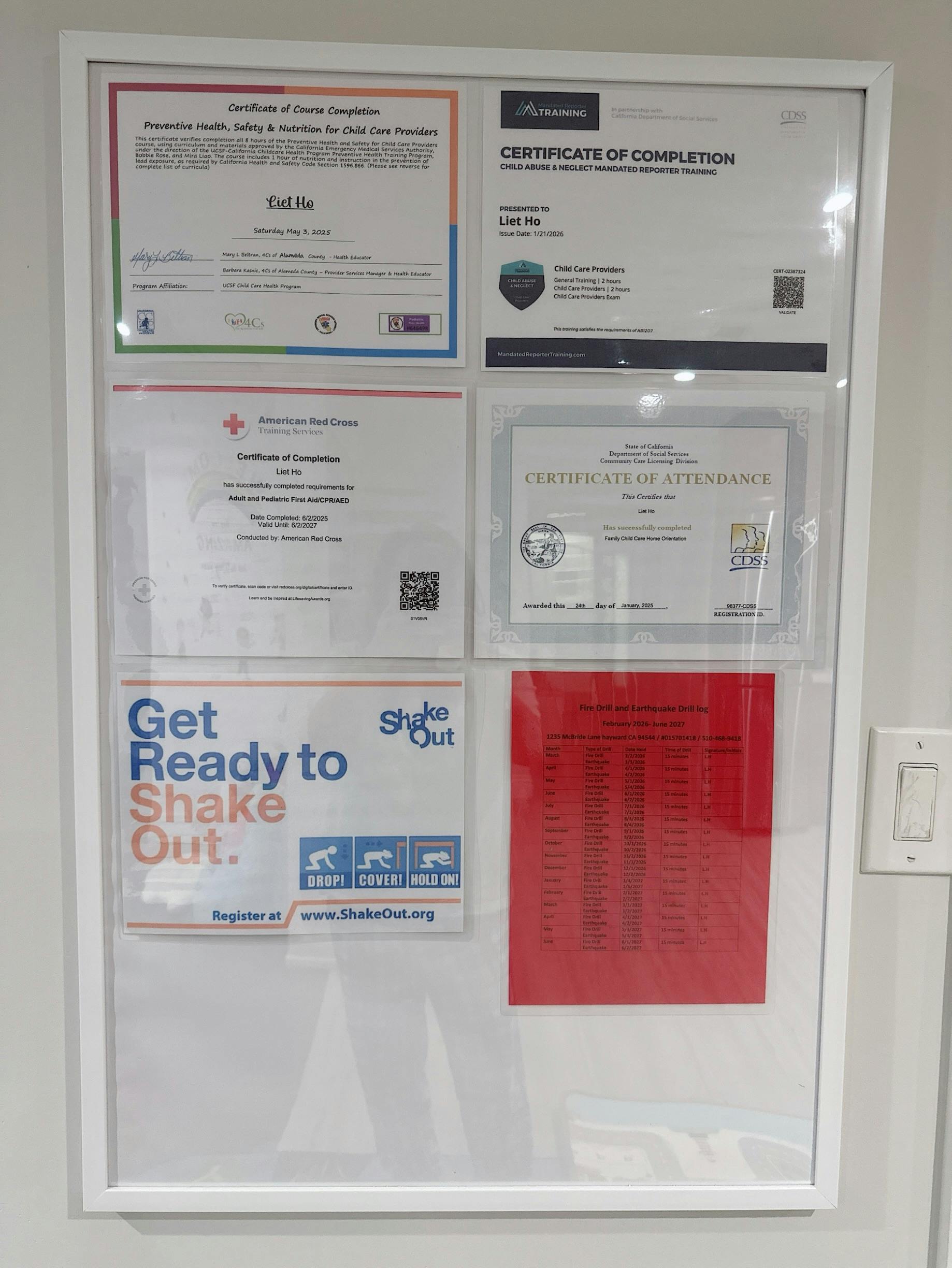 Certificates and a fire drill log displayed on a white board
