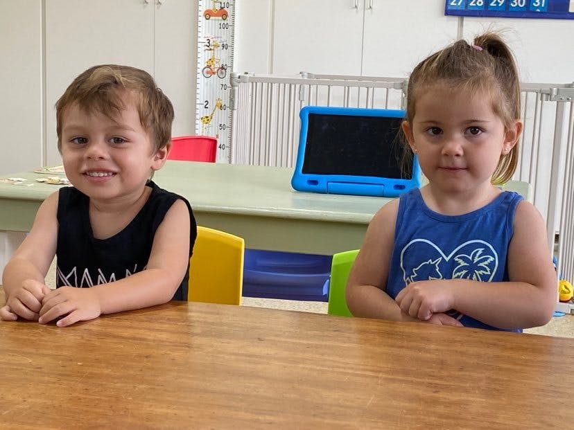 Two children sitting at a table