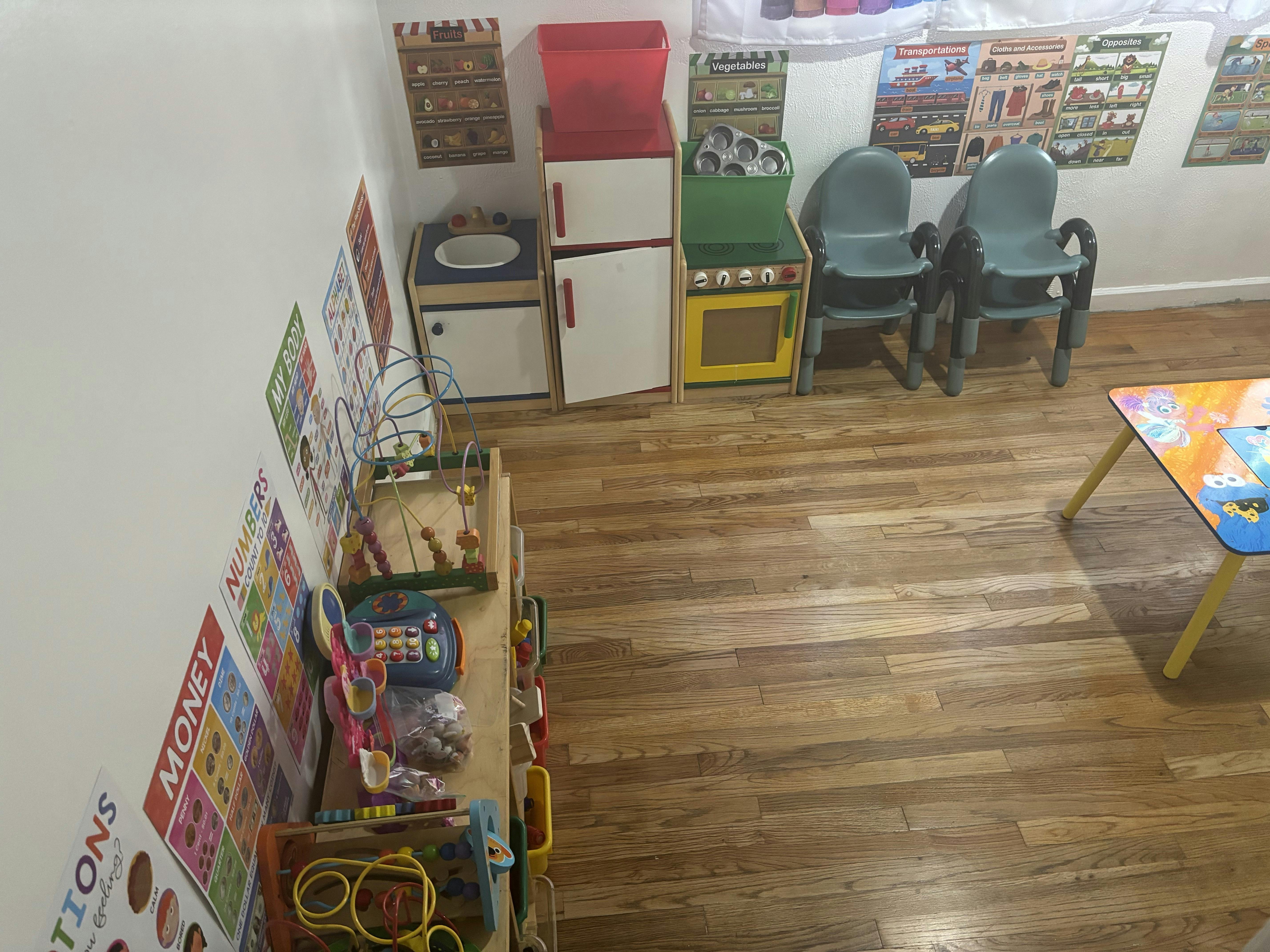 Playroom with toy kitchen, small chairs, and a table