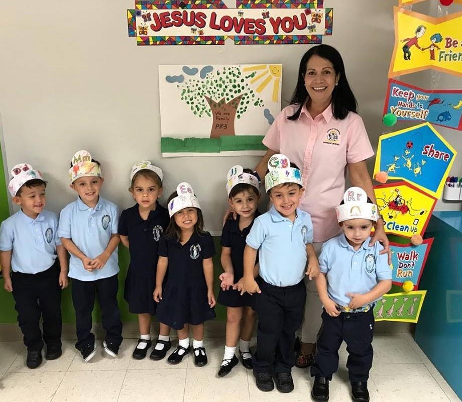 Adult and multiple children in a classroom