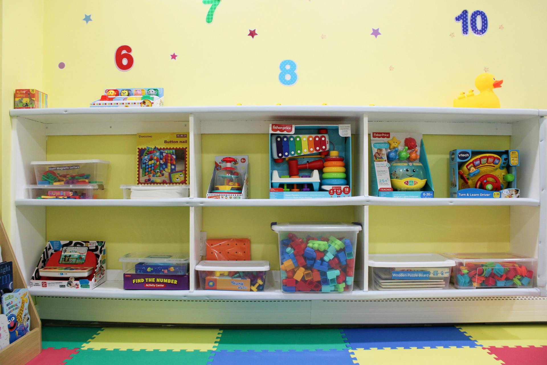 Shelves filled with various toys and educational items in a classroom