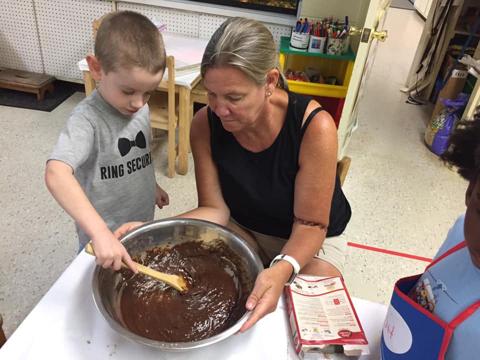 Adult and child mixing batter in a bowl