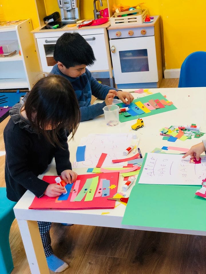 Two children doing crafts at a table