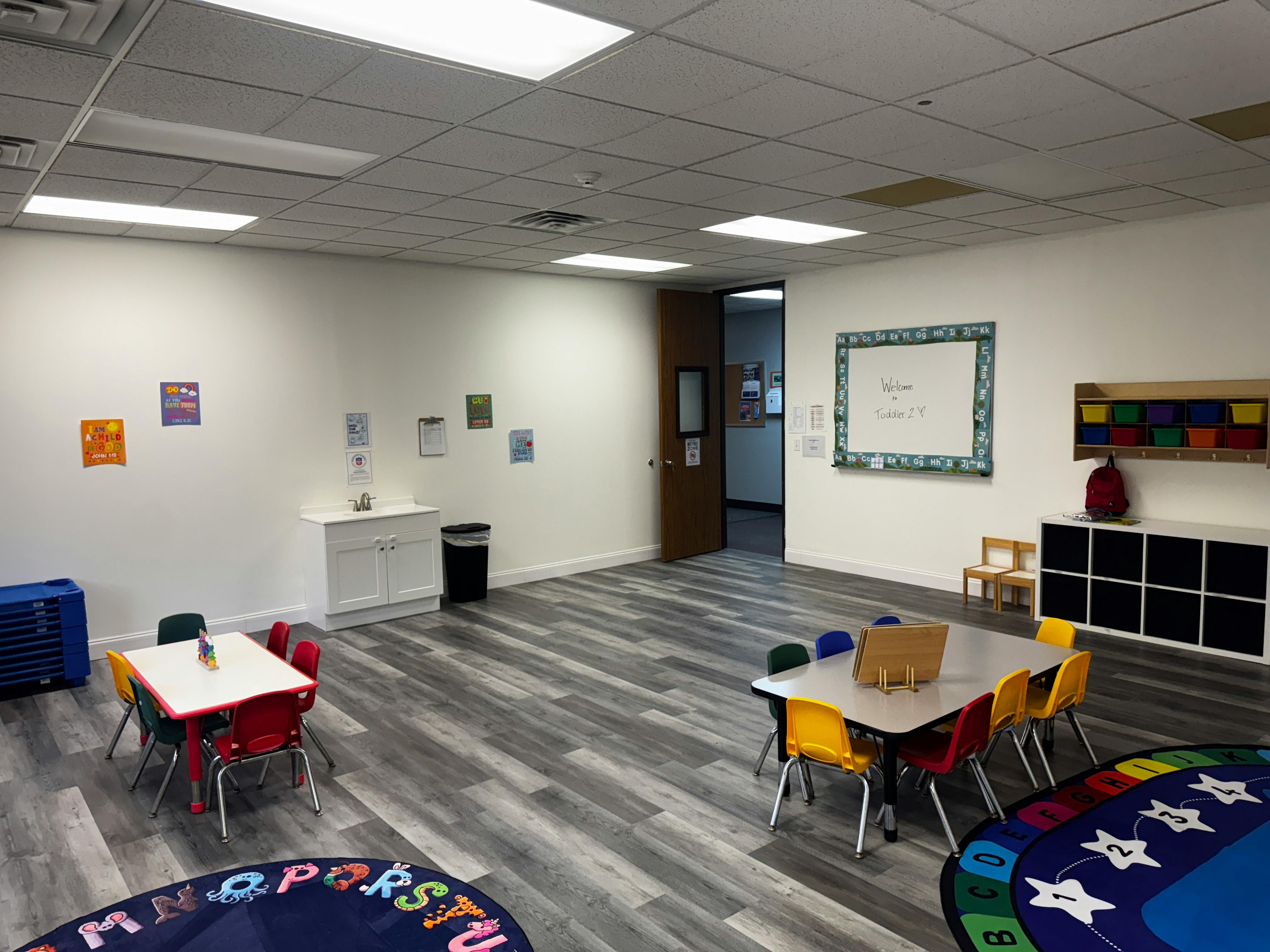 Empty classroom with small tables and chairs