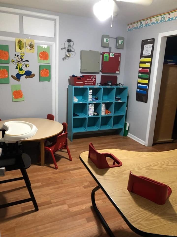 Classroom with tables, chairs, and storage cubbies