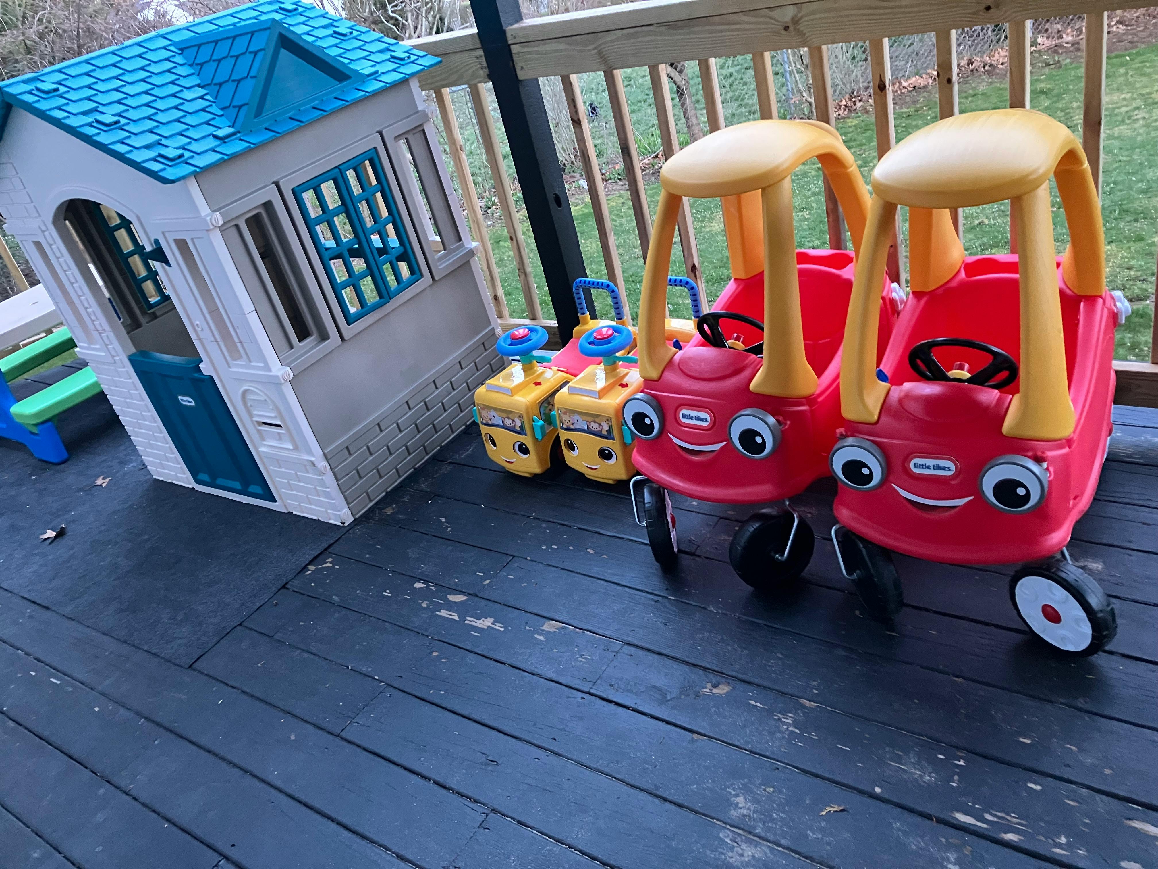 Playhouse and toy cars on a deck