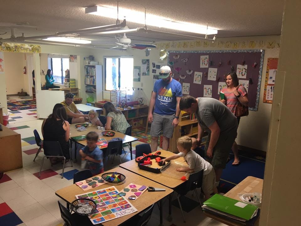 Adults and children in a classroom