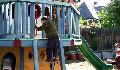 Child climbing a ladder on a playground structure