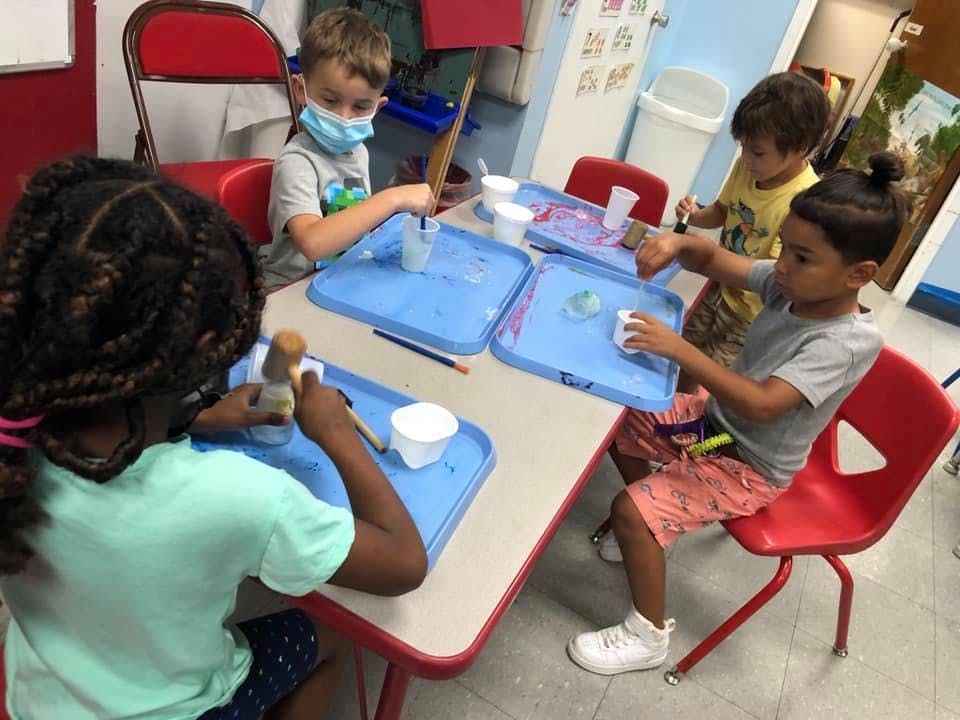 Children at a table with art supplies