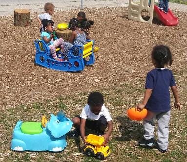 Children playing with toys on a playground