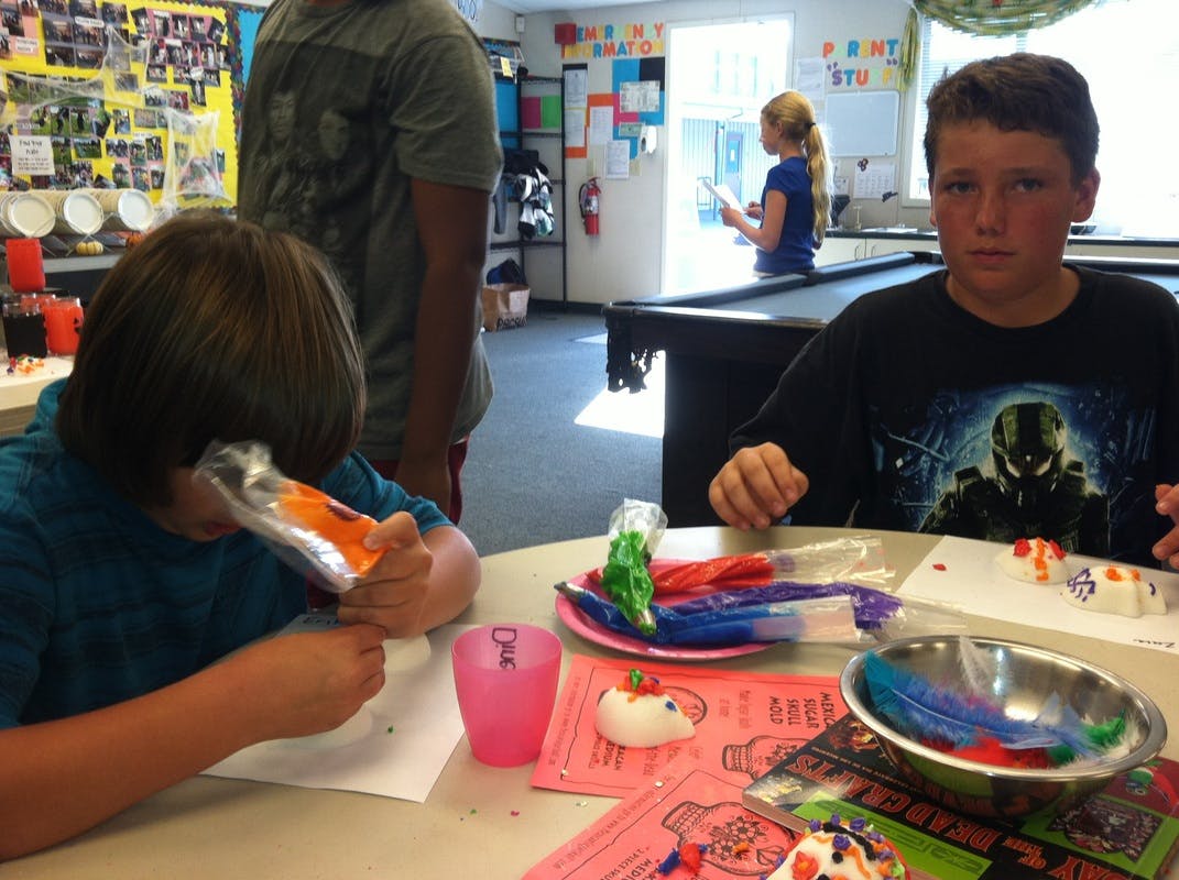 Two children at a table with craft supplies