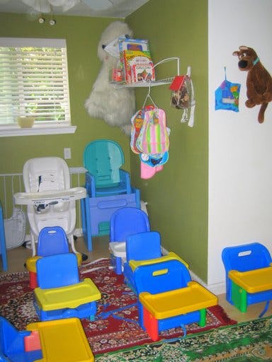 Children's chairs and high chairs in a room with a window