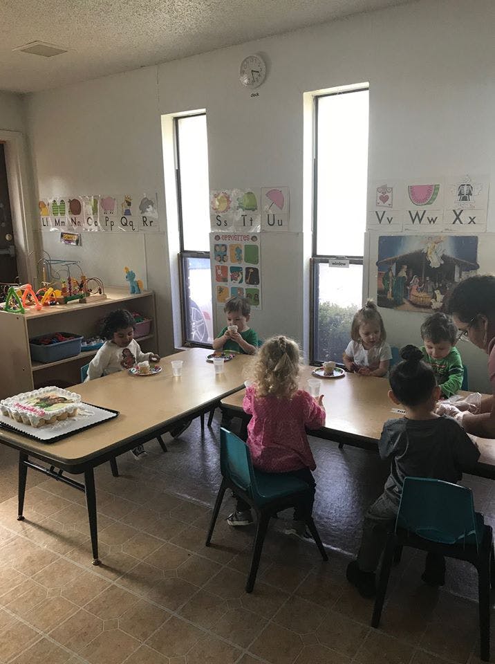 Children sitting at tables in a classroom