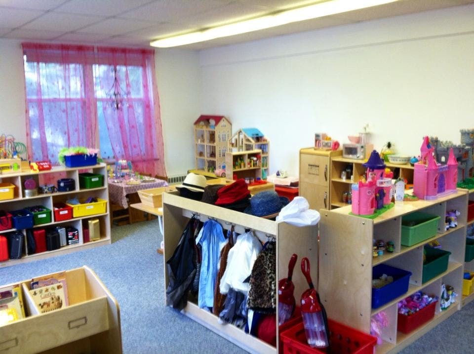 Classroom with shelves of toys and dress-up clothes