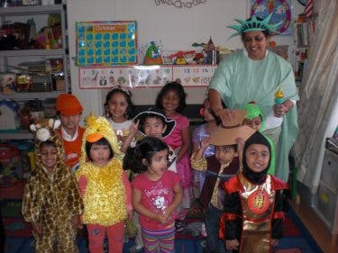 Adult in Statue of Liberty costume with children in various costumes