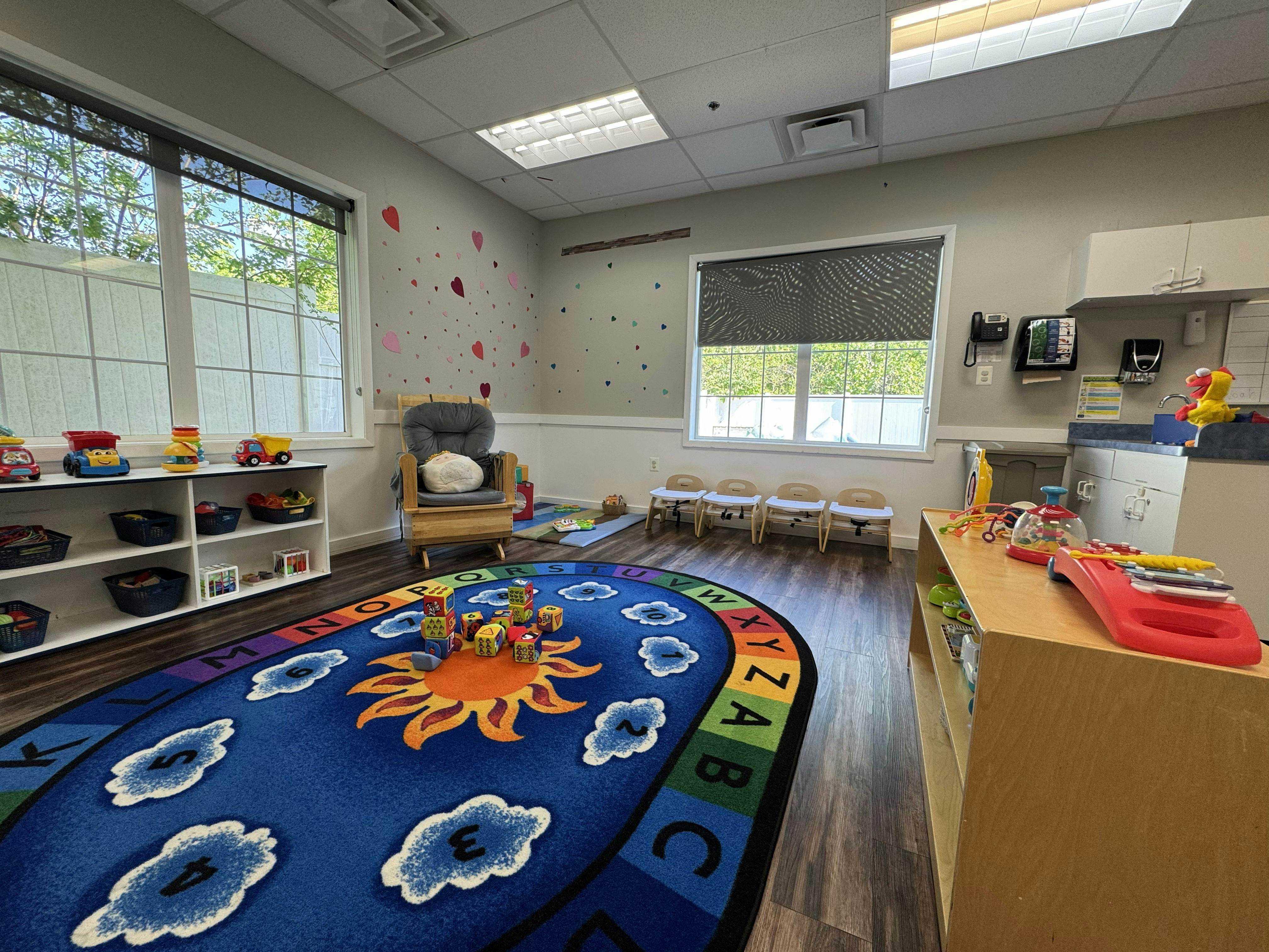 Children's classroom with alphabet rug toys and small chairs